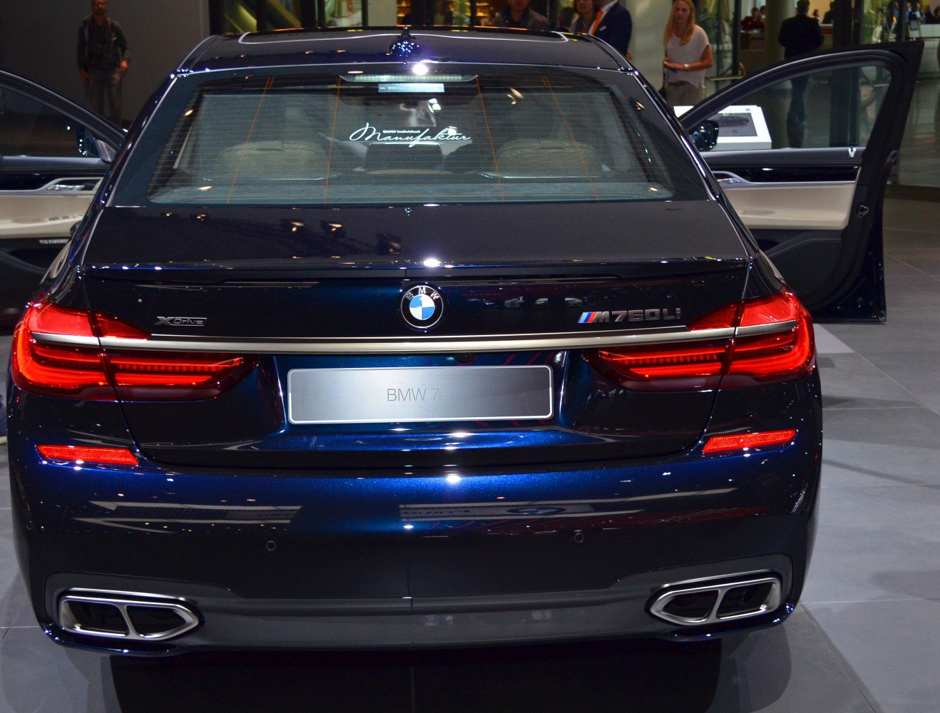Rear view showing taillights, M760Li xDrive badge, and dual exhausts