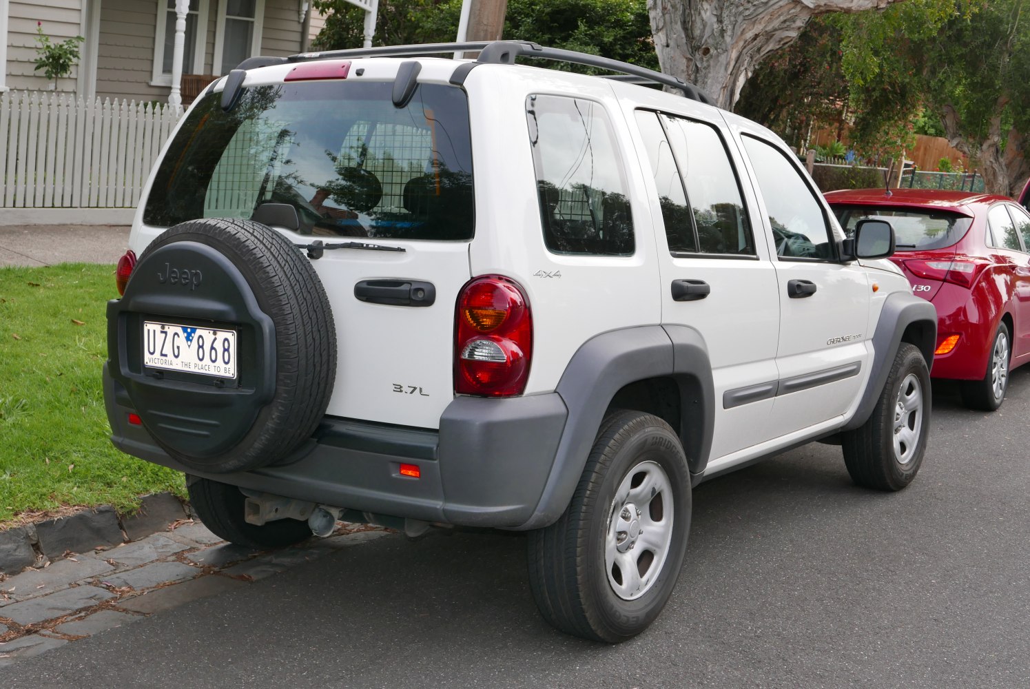 Rear view of SUV with spare tire on back door and 4x4 badge