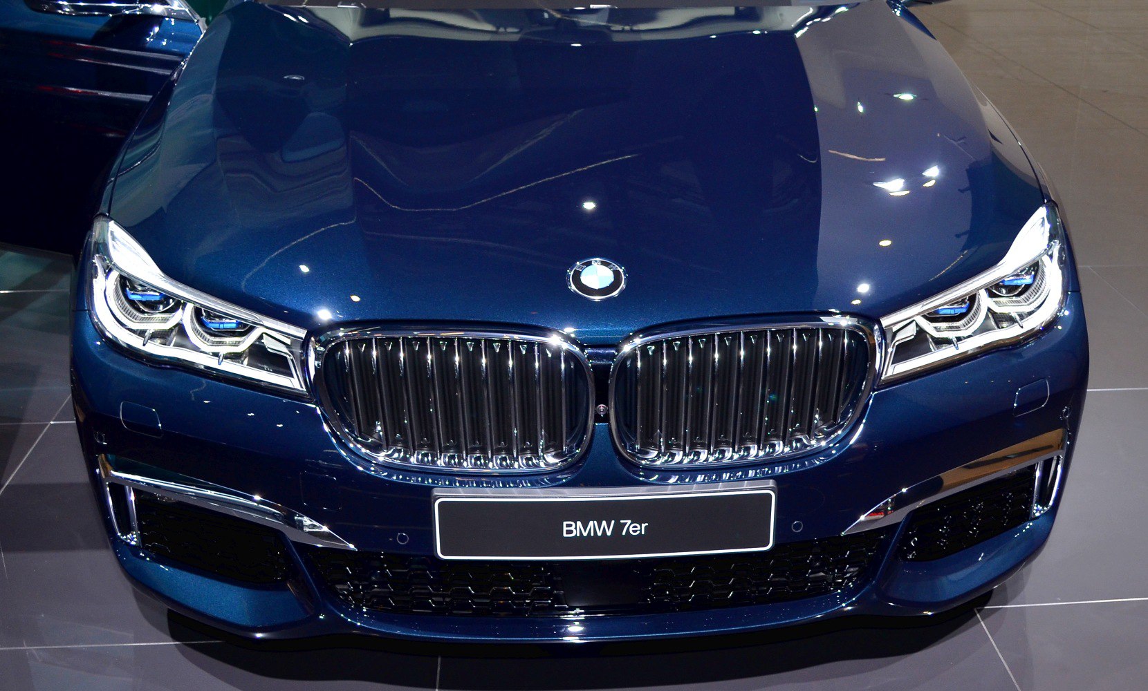 Close-up of BMW kidney grille and LED headlights.