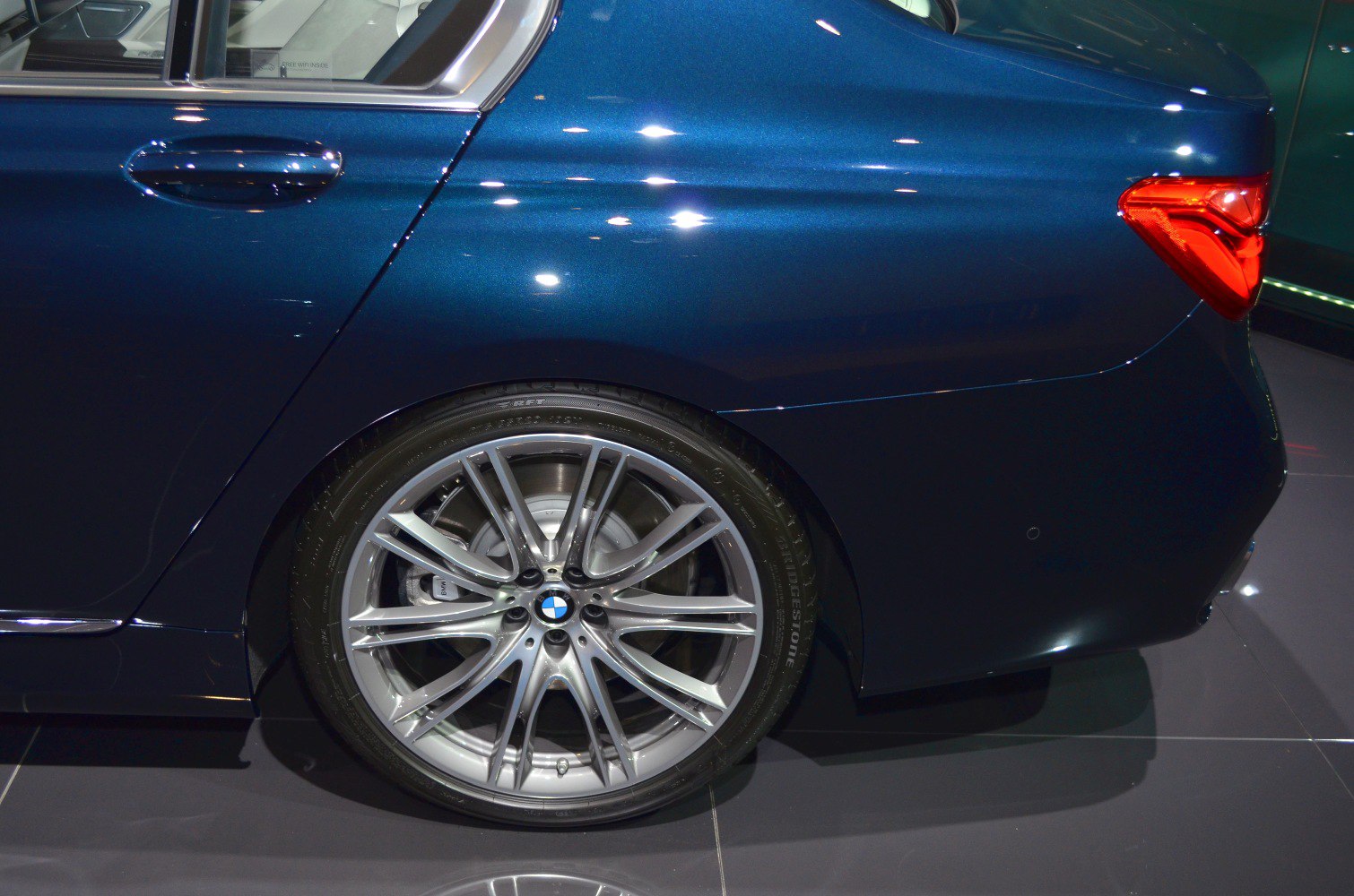 Alloy rear wheel and tail light on luxury sedan rear quarter
