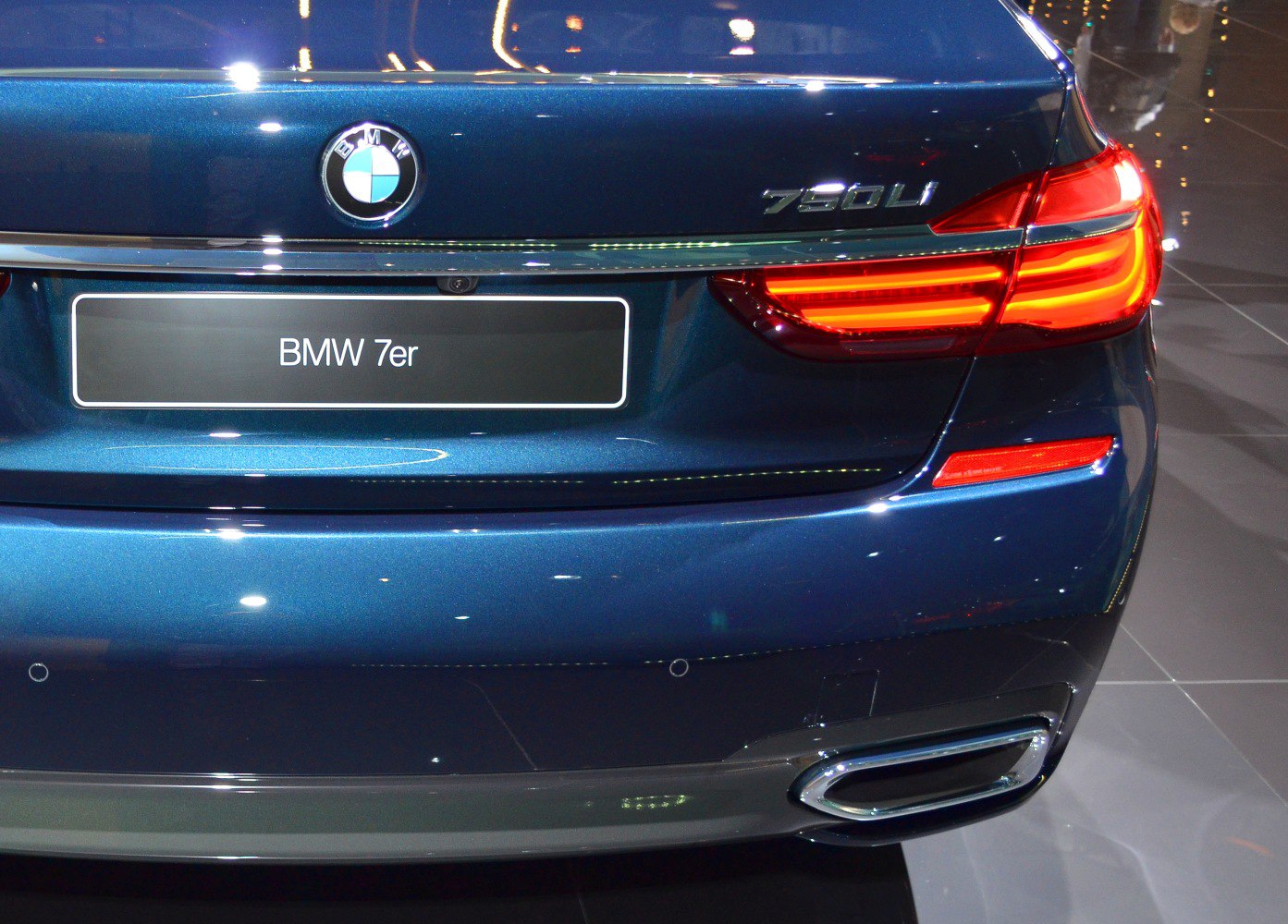 Rear LED tail lights and dual exhaust tips on luxury sedan rear