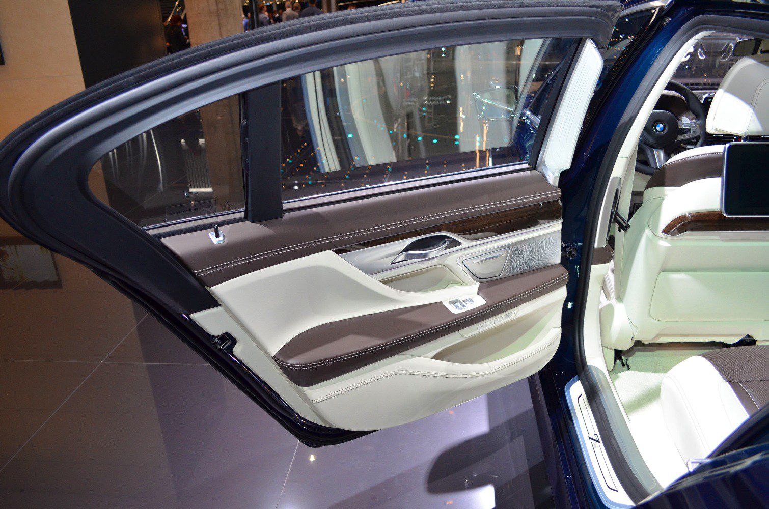 Luxury rear door interior with wood trim and dual-tone leather upholstery