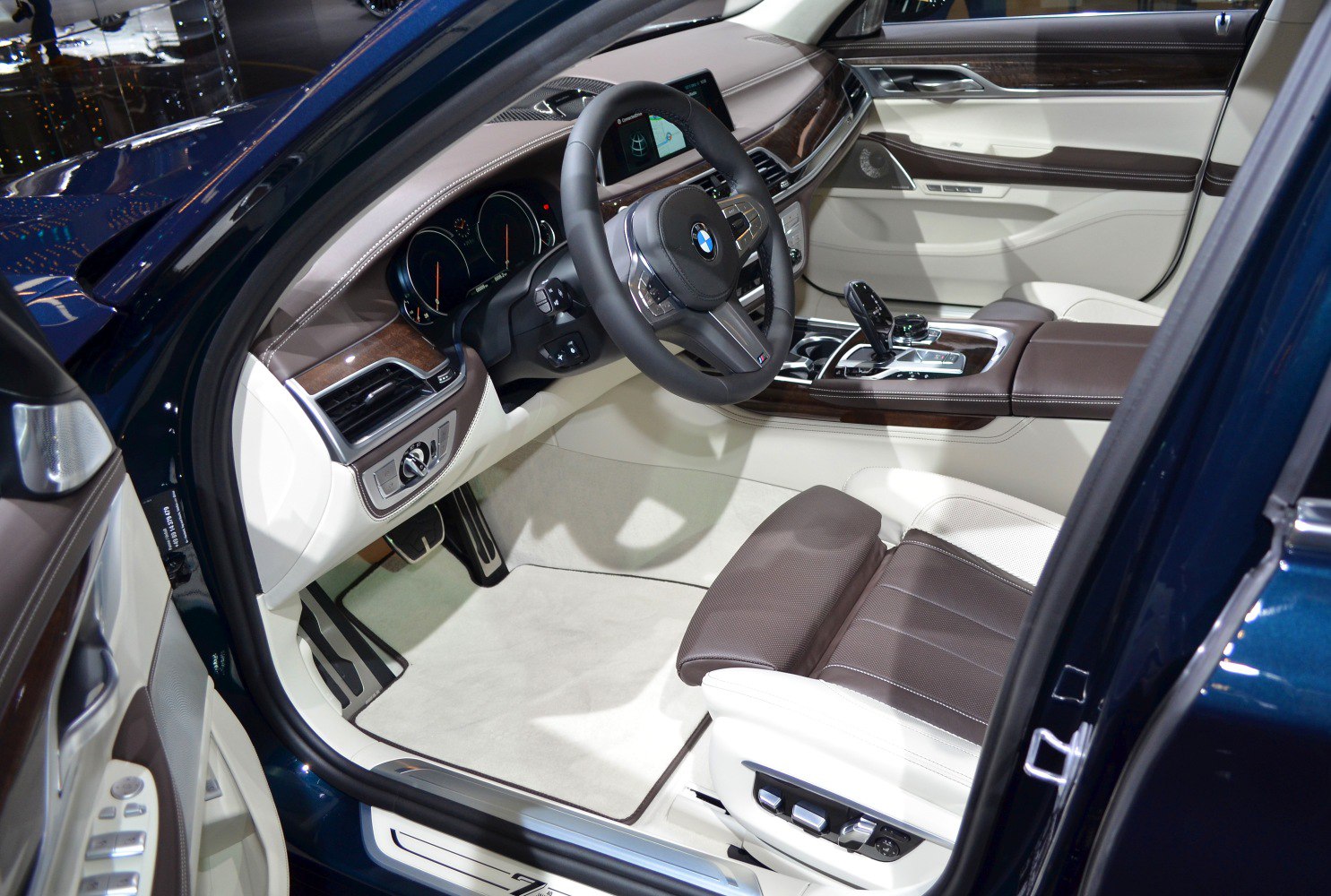 Luxury interior cabin with leather seats, wooden trim, and advanced cockpit controls