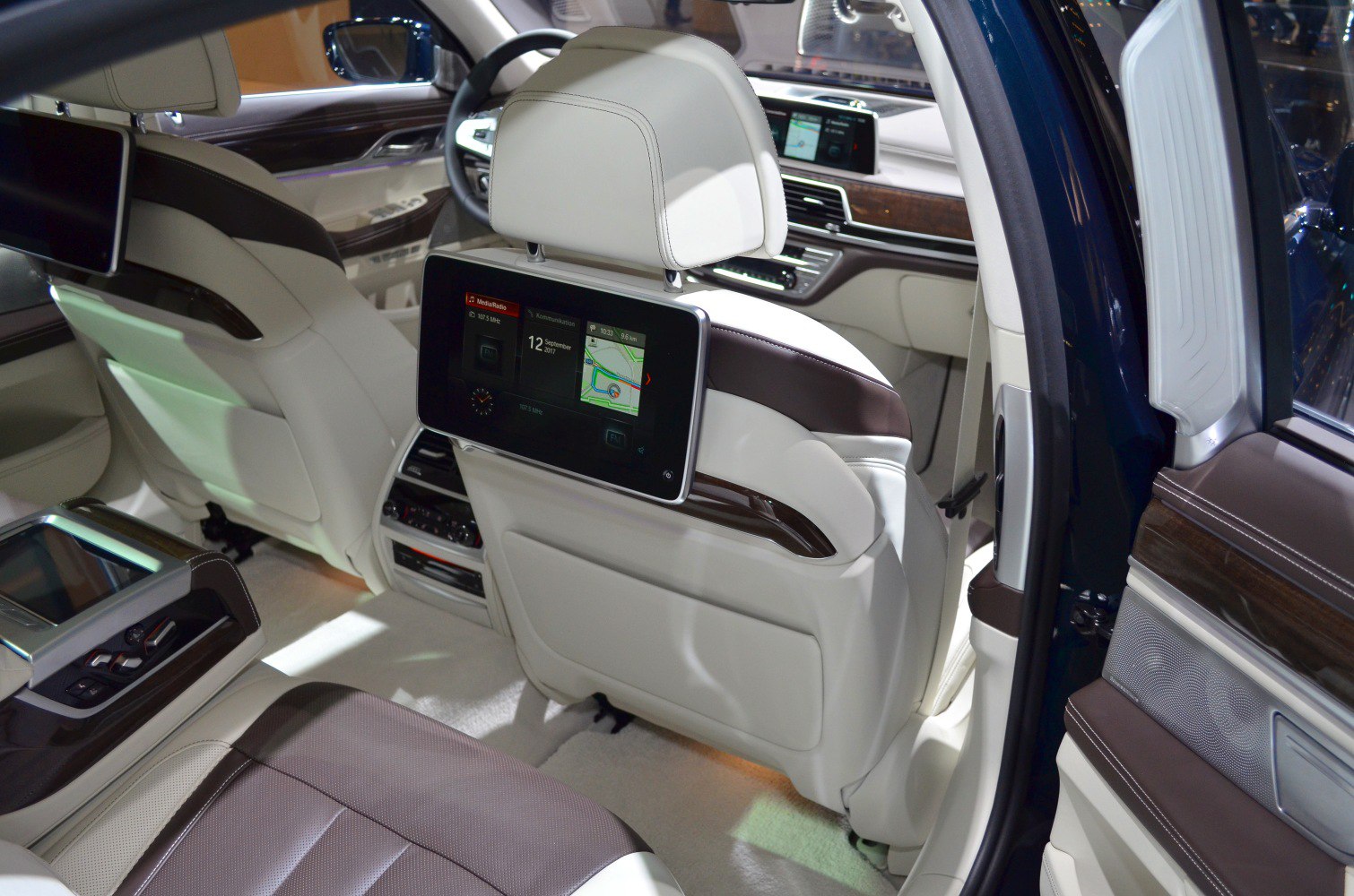 Premium rear seat touchscreen entertainment system in beige and brown leather interior