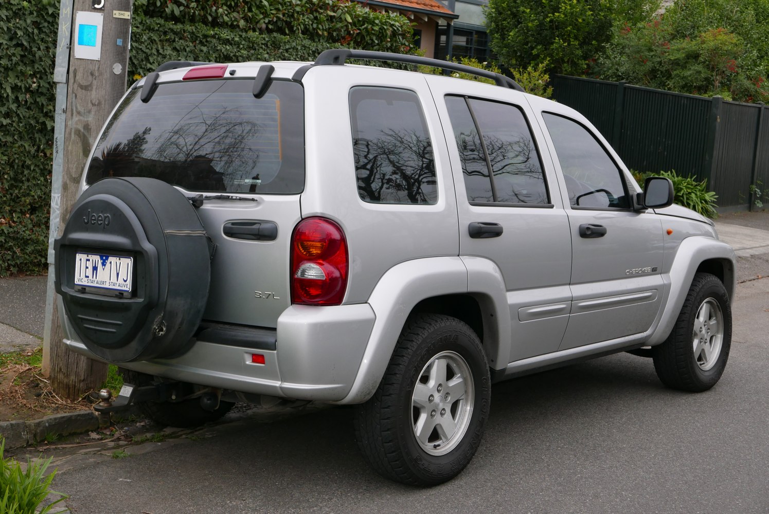 SUV rear side view with spare tire cover and tinted windows