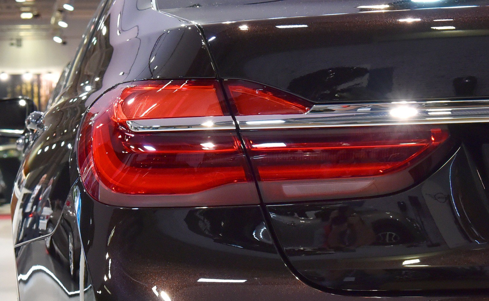 Close-up of rear LED tail light on reflective black body