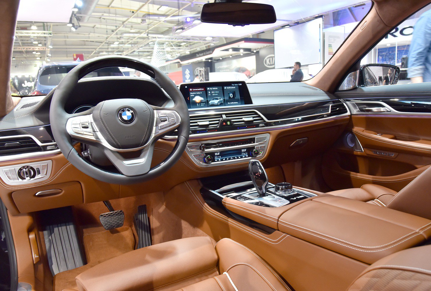 Luxury brown leather interior with digital dashboard and steering wheel