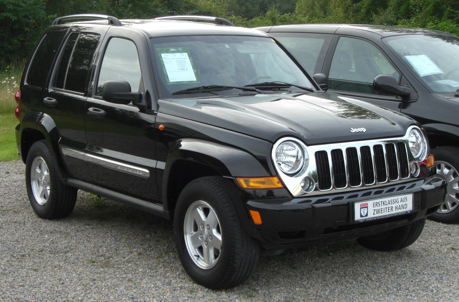 Black SUV with round headlights and chrome front grille