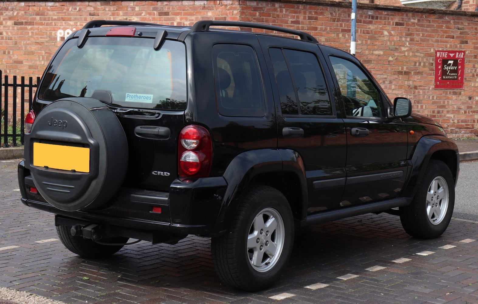 Rear view of black SUV with spare wheel mounted on tailgate
