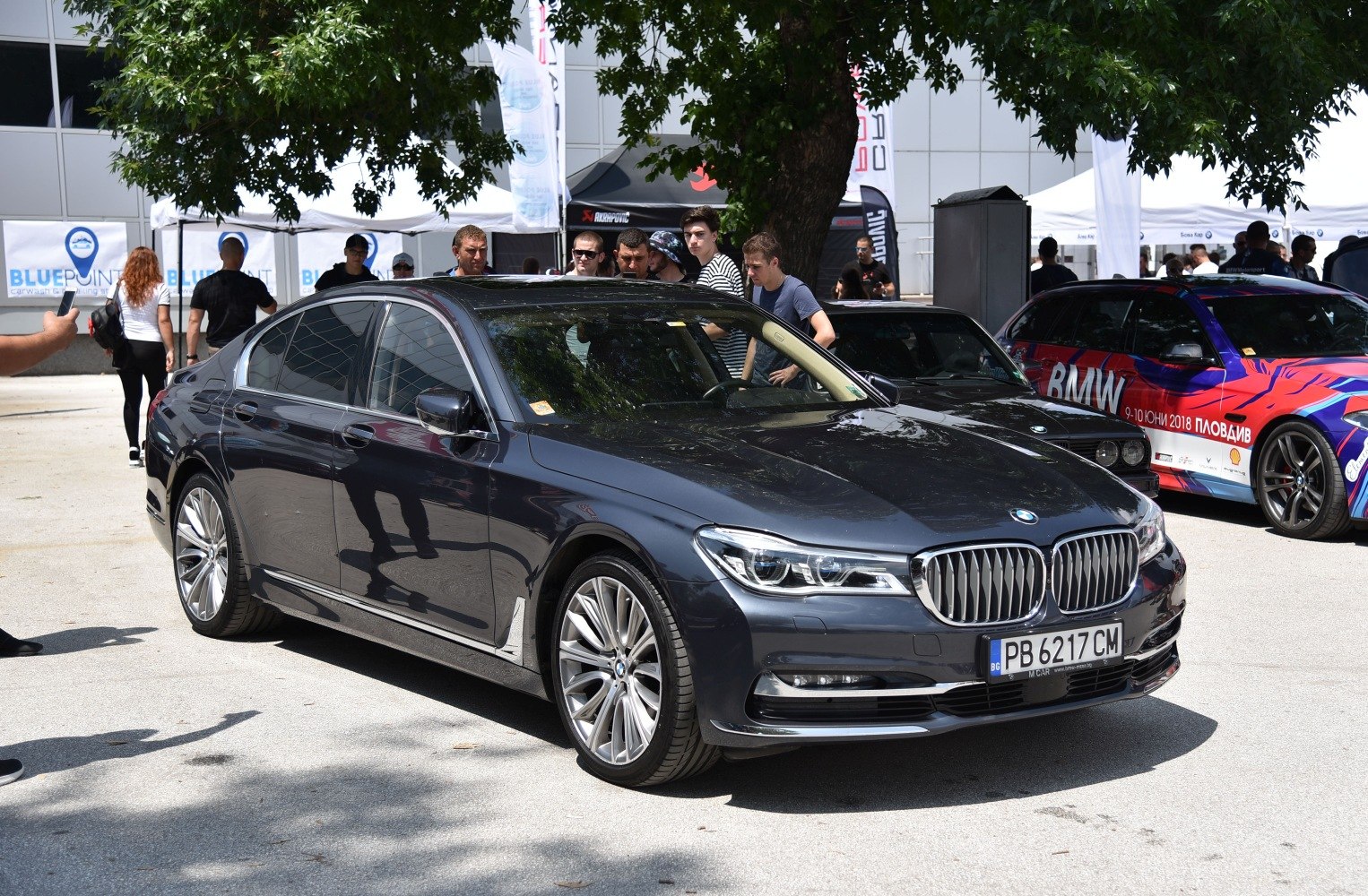 Luxury sedan front-side view with kidney grille and alloy wheels