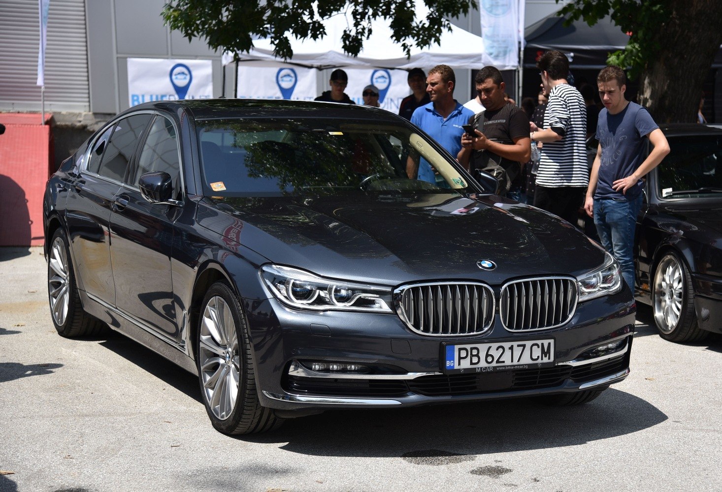 Luxury sedan front view with LED headlights and kidney grille