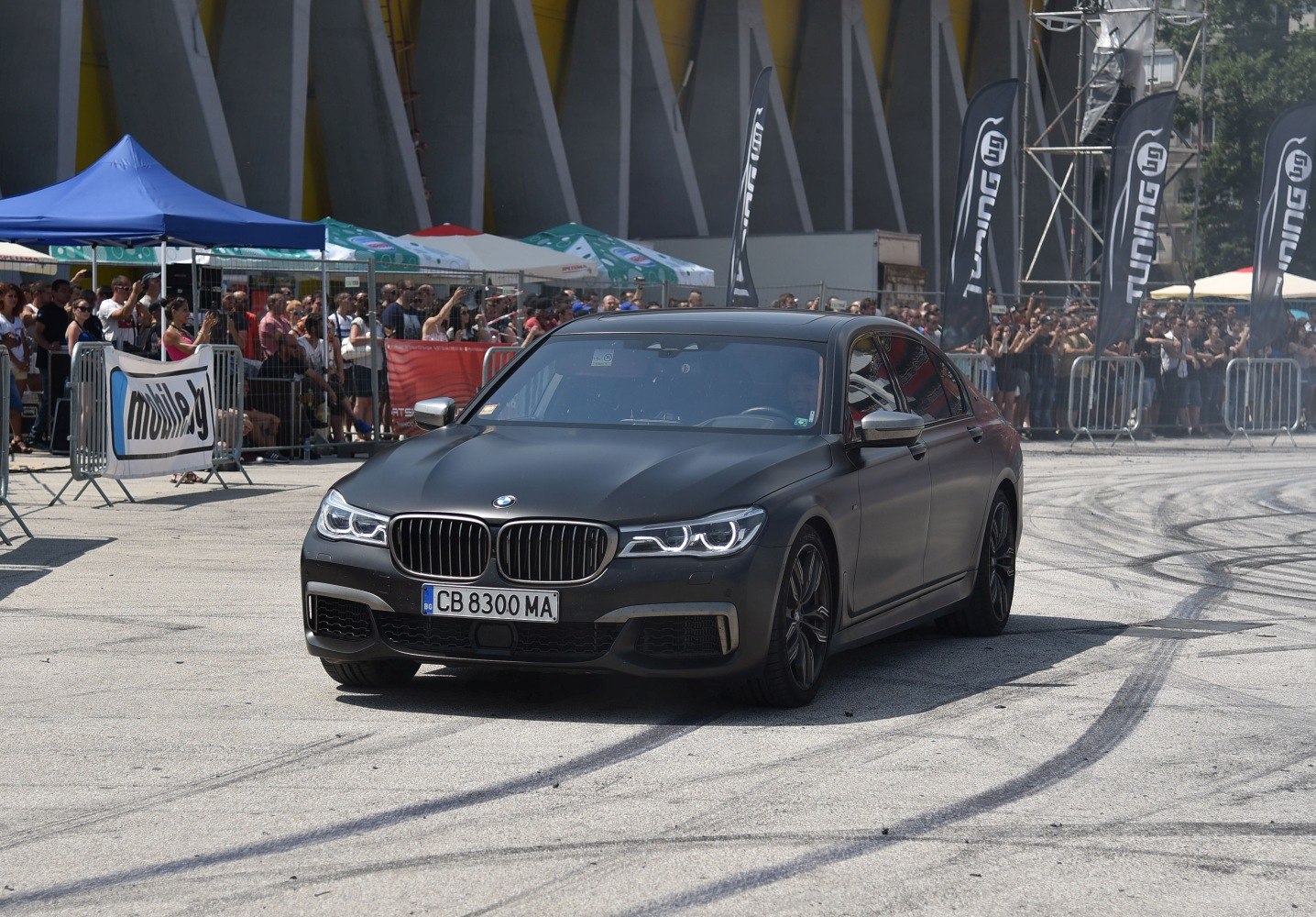 Matte black luxury sedan with LED headlights and sporty design