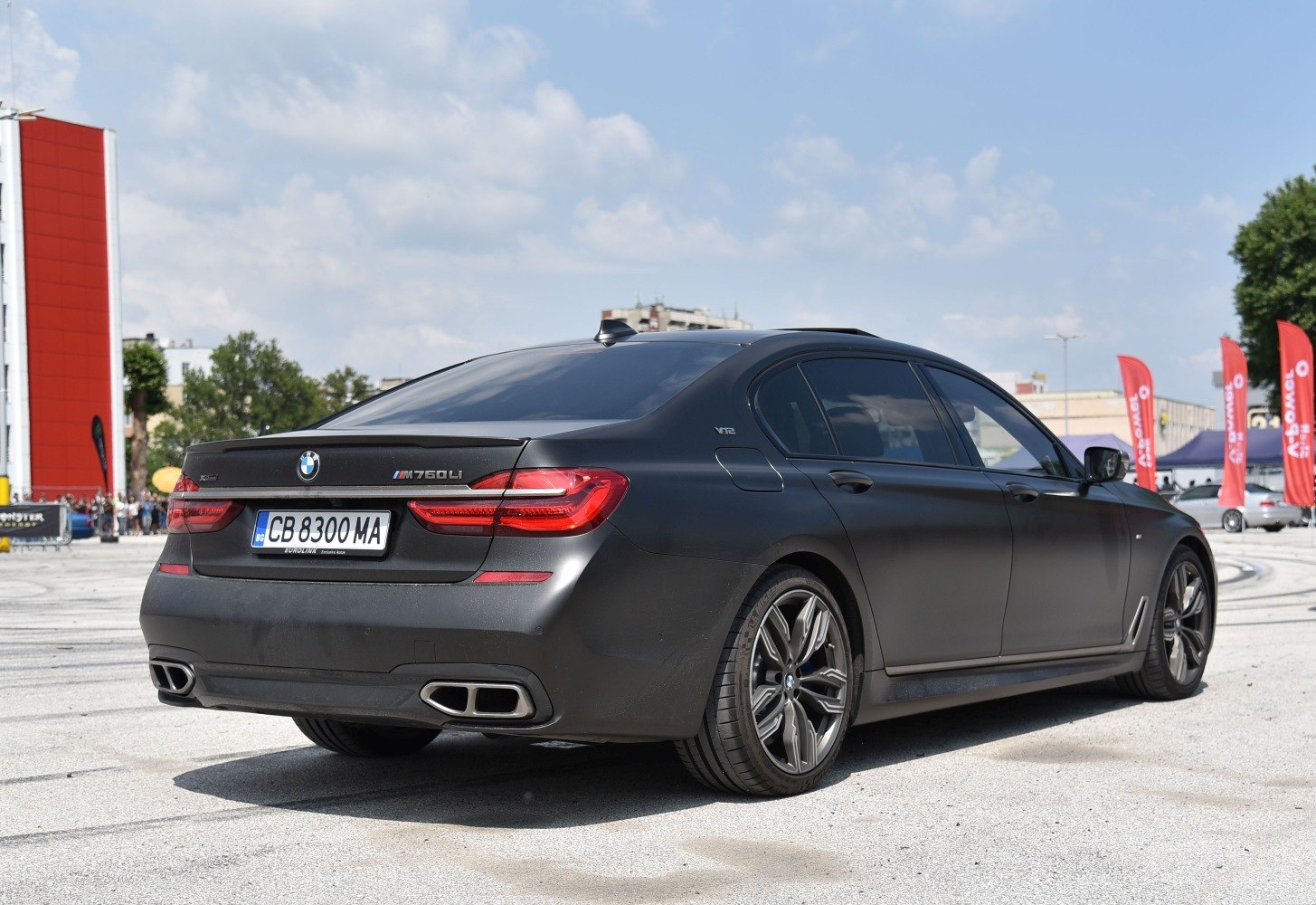 Rear view of luxury sedan with quad exhaust and sleek taillights