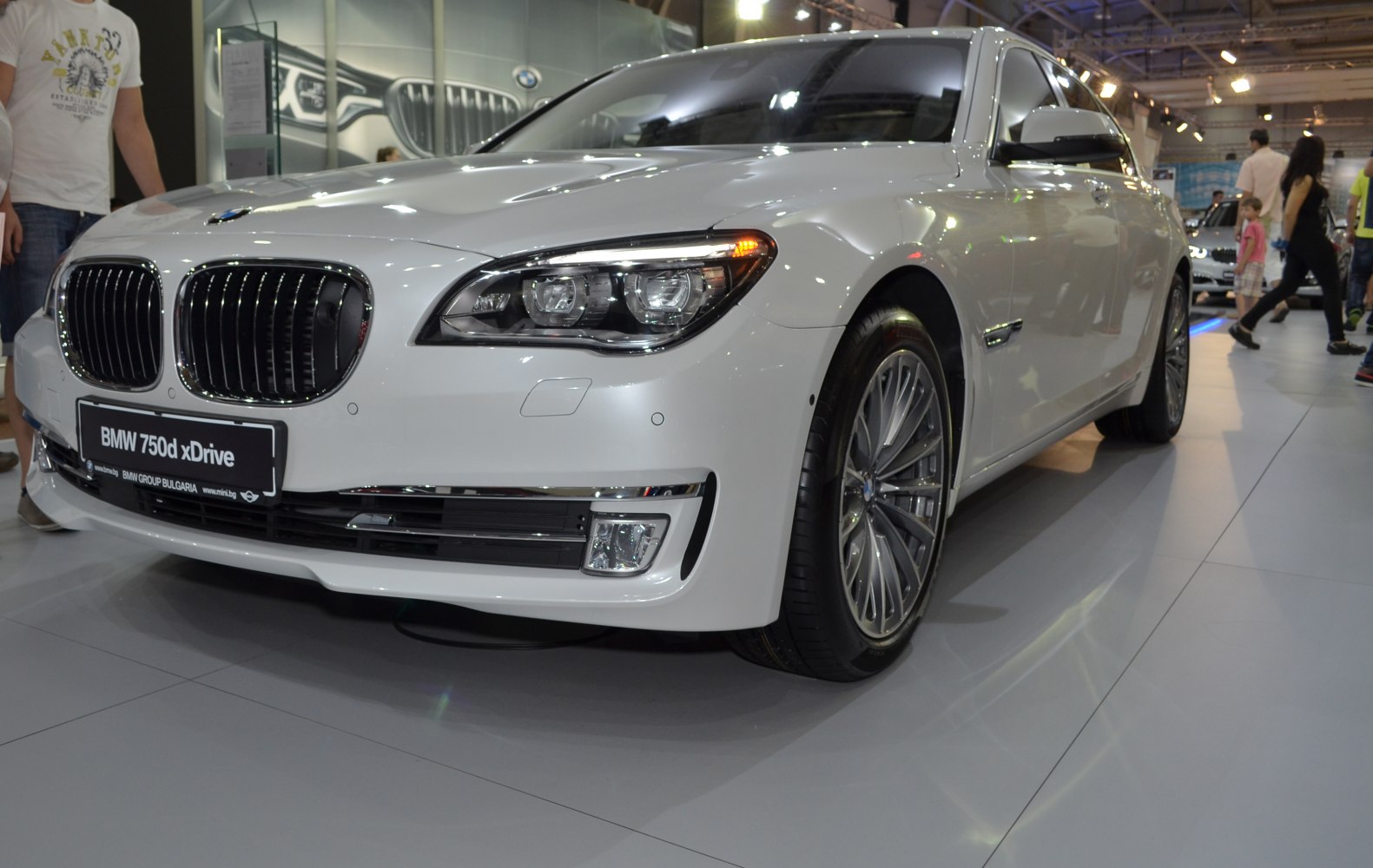 Front view with LED headlights, kidney grille, and multi-spoke alloy wheel