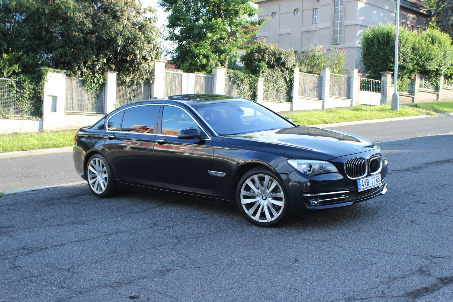 Luxury sedan front side view with long wheelbase and sleek body.