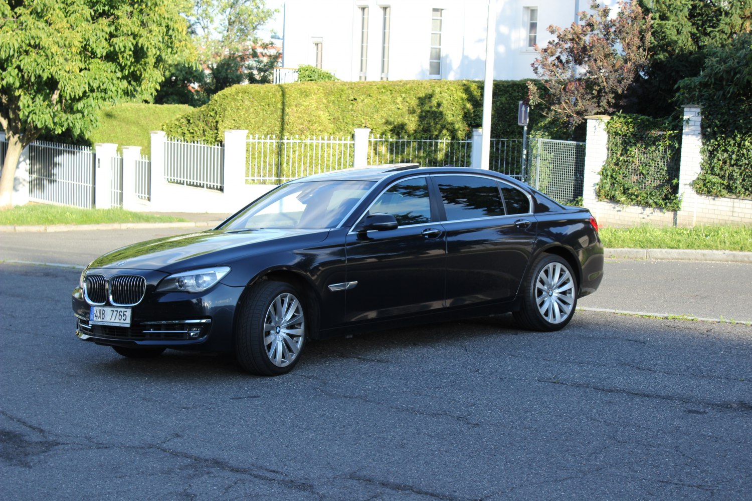 Luxury sedan front side view with alloy wheels and sunroof