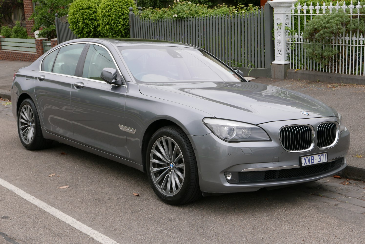 Front-side view of luxury sedan with kidney grille and alloy wheels
