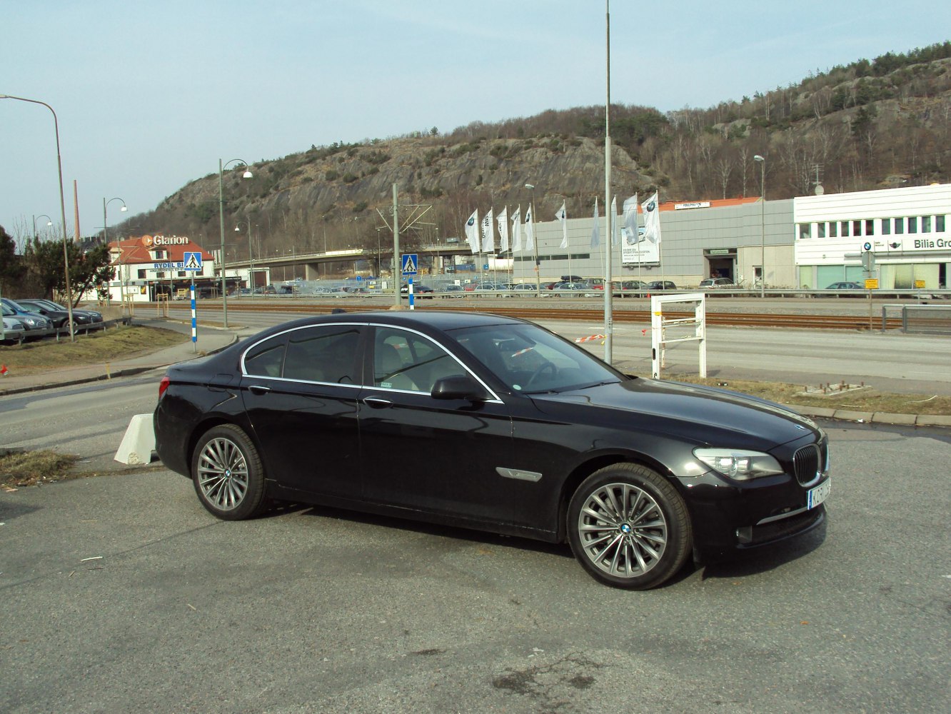Black luxury sedan side profile with alloy wheels