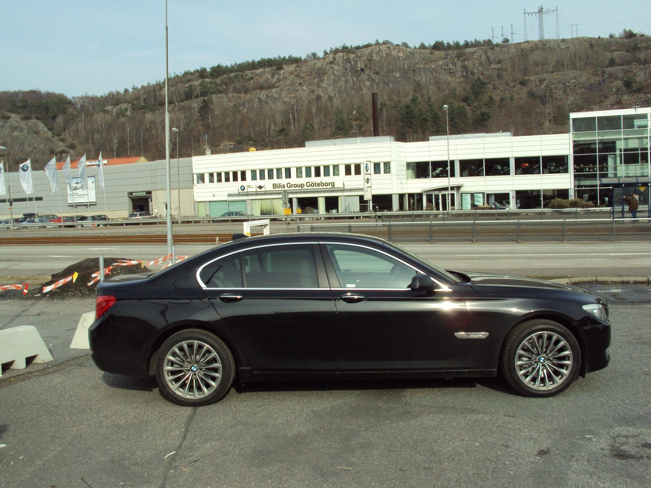 Black luxury sedan with multi-spoke alloy wheels and chrome window trim