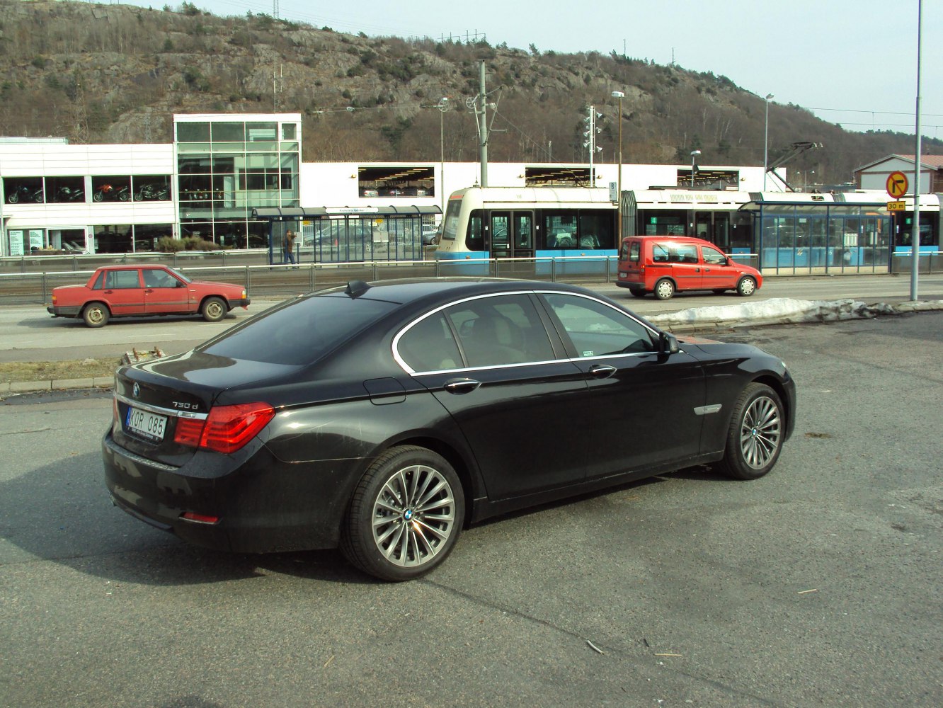 Rear side profile of black luxury sedan with alloy wheels