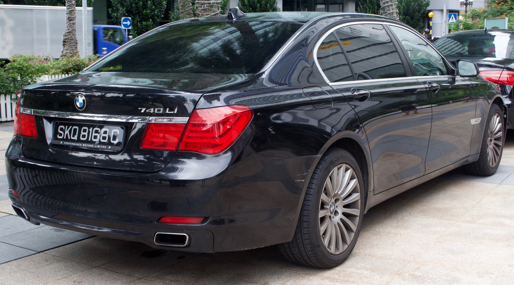 Rear view of luxury sedan with dual exhausts and distinctive taillights