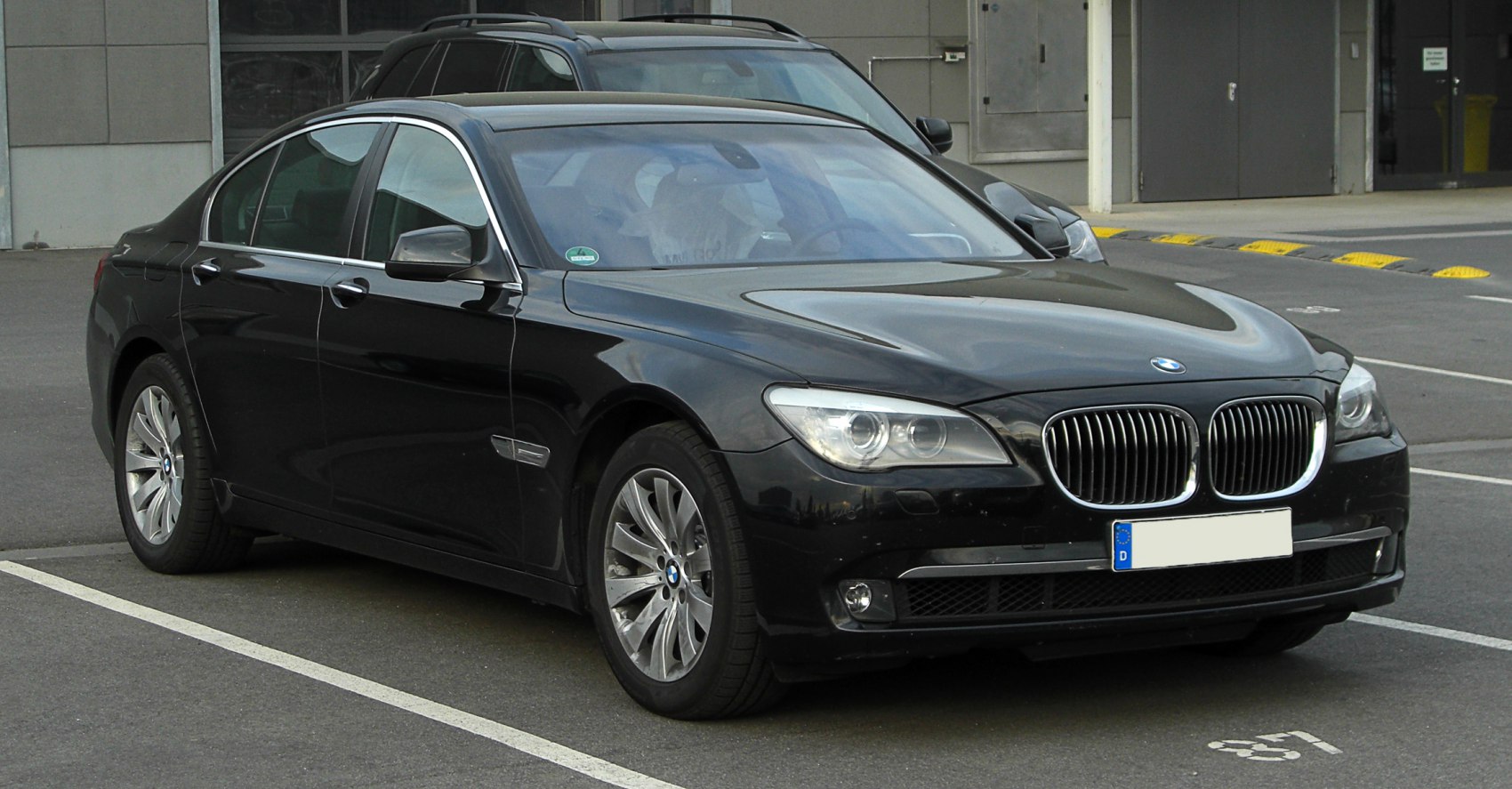 Front side view of luxury sedan with kidney grille and distinct headlamps