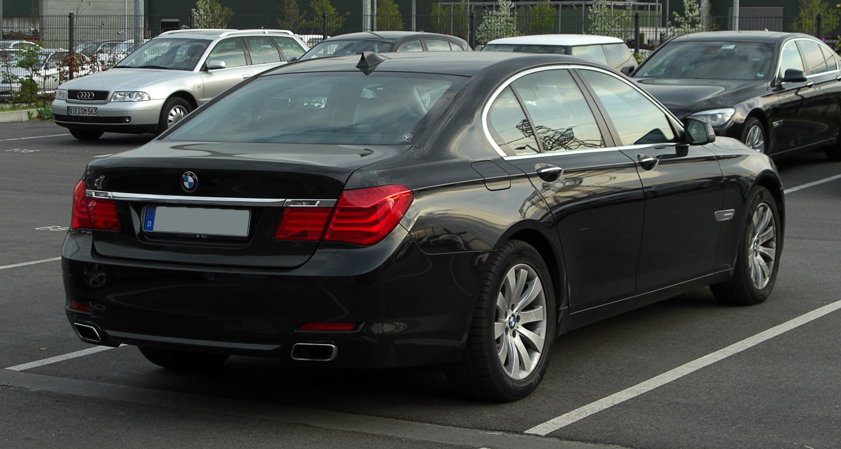 Rear view of luxury sedan with distinctive taillights and dual exhausts