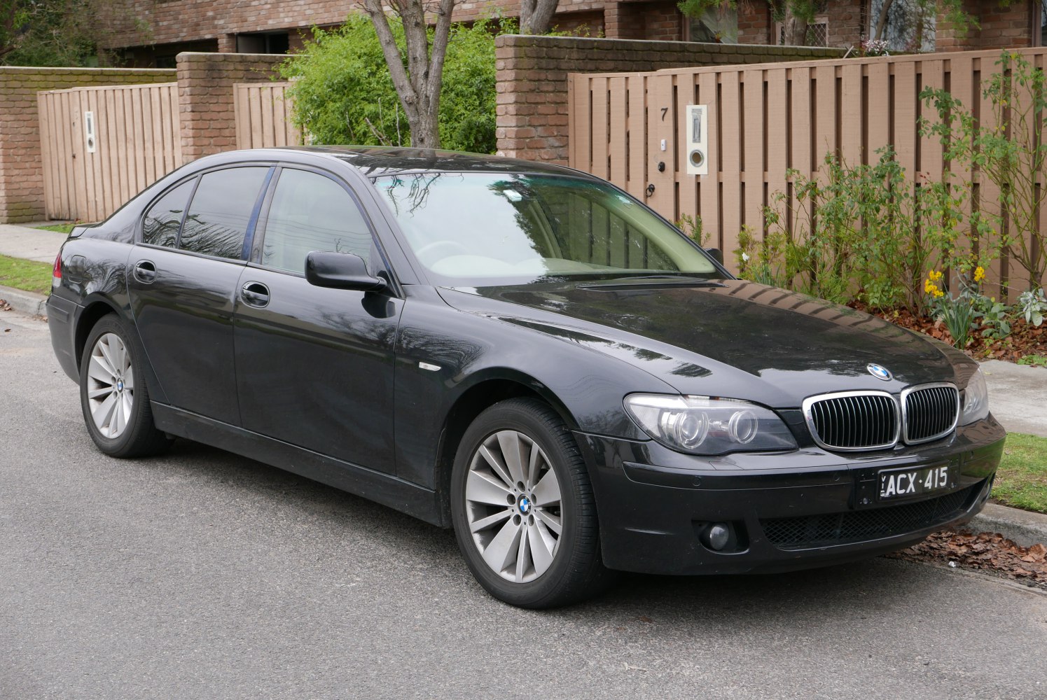 Front side view of a luxury sedan with distinct headlights and kidney grille