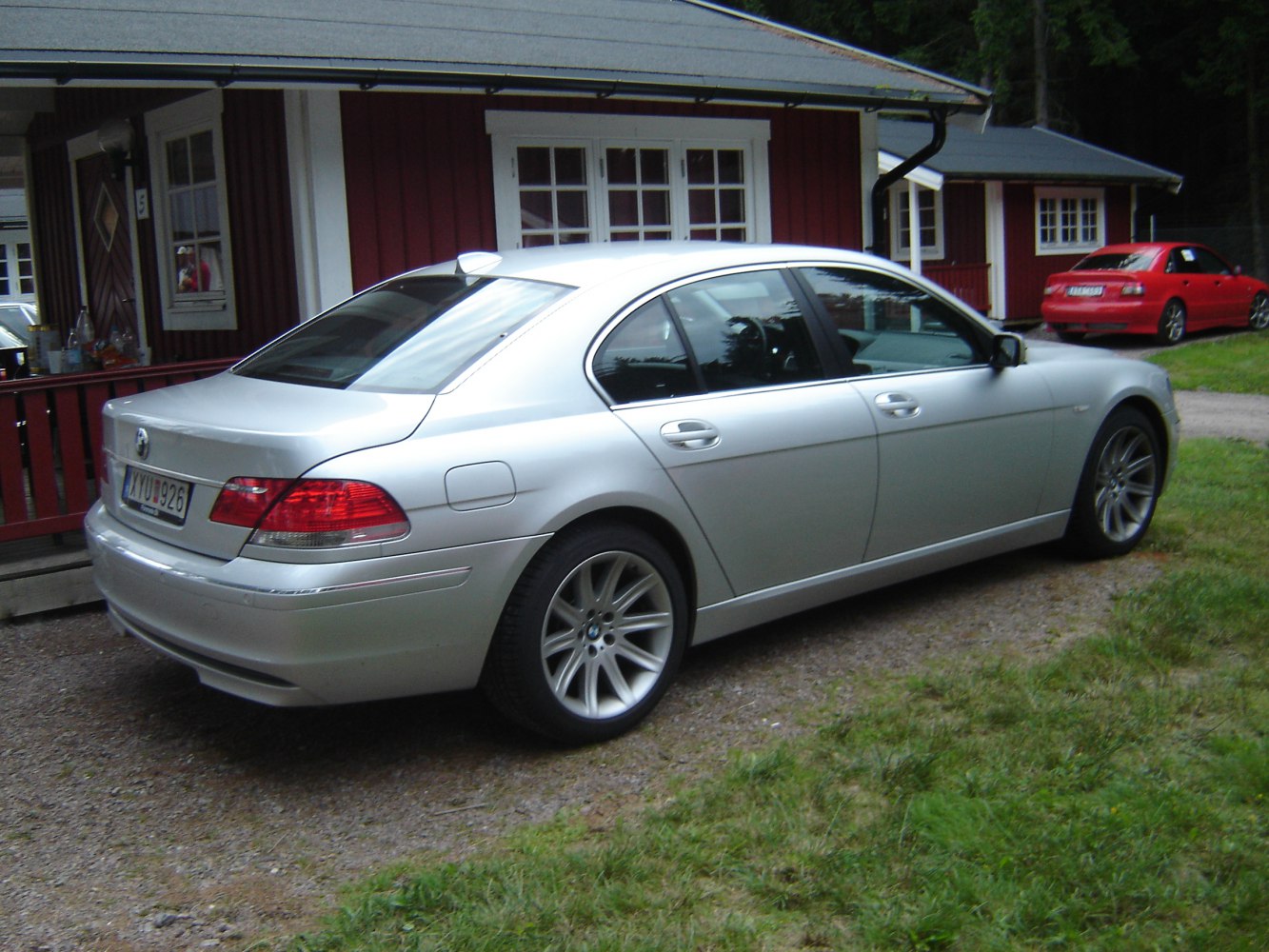 Silver luxury sedan rear and side view with alloy wheels
