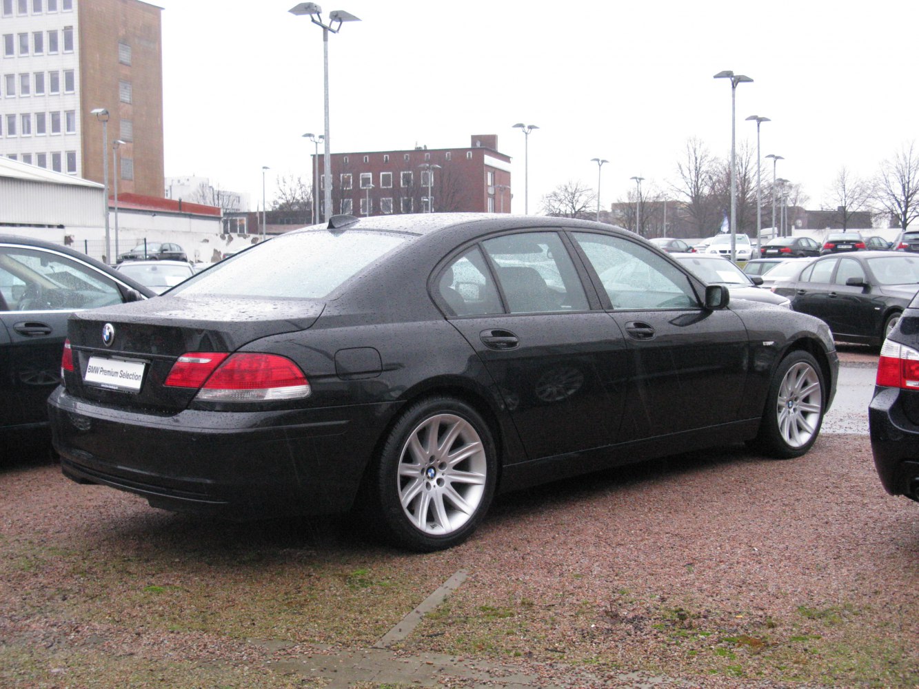 Rear side view of luxury sedan with alloy wheels.