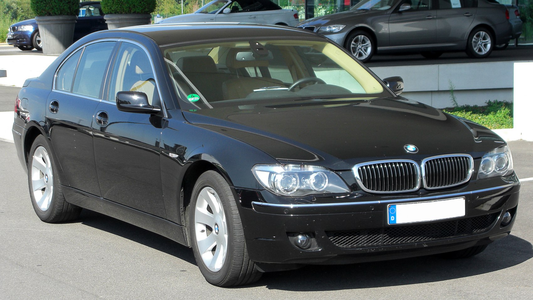 Front side view of luxury sedan with kidney grille and dual round headlights
