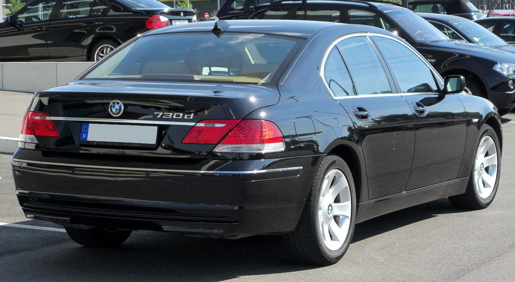 Rear view of black luxury sedan with distinctive taillights and 730d badge