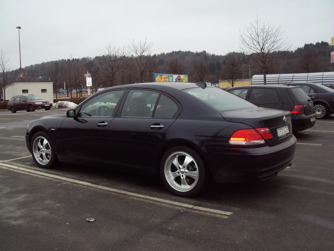Rear side view of luxury sedan with alloy wheels