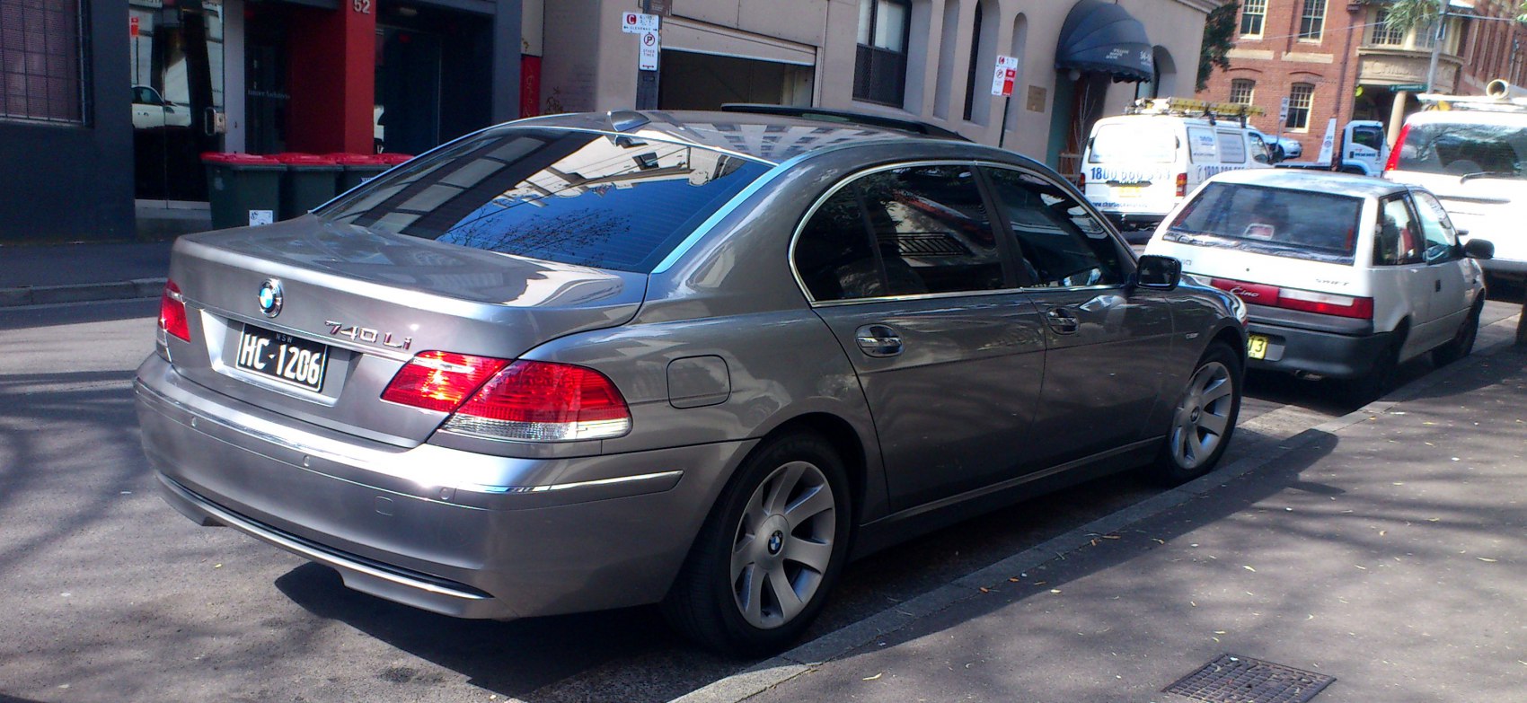 Silver long wheelbase luxury sedan rear side with distinctive tail lights