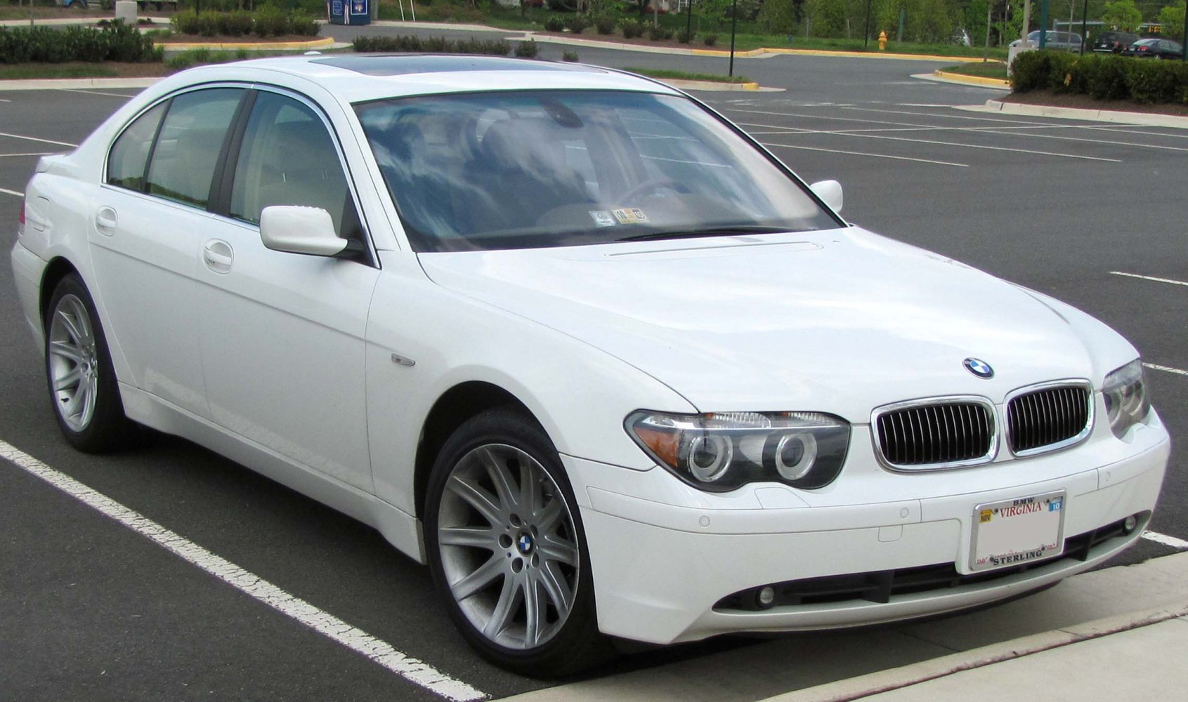 White luxury sedan with kidney grille, angel eye headlights, alloy wheels