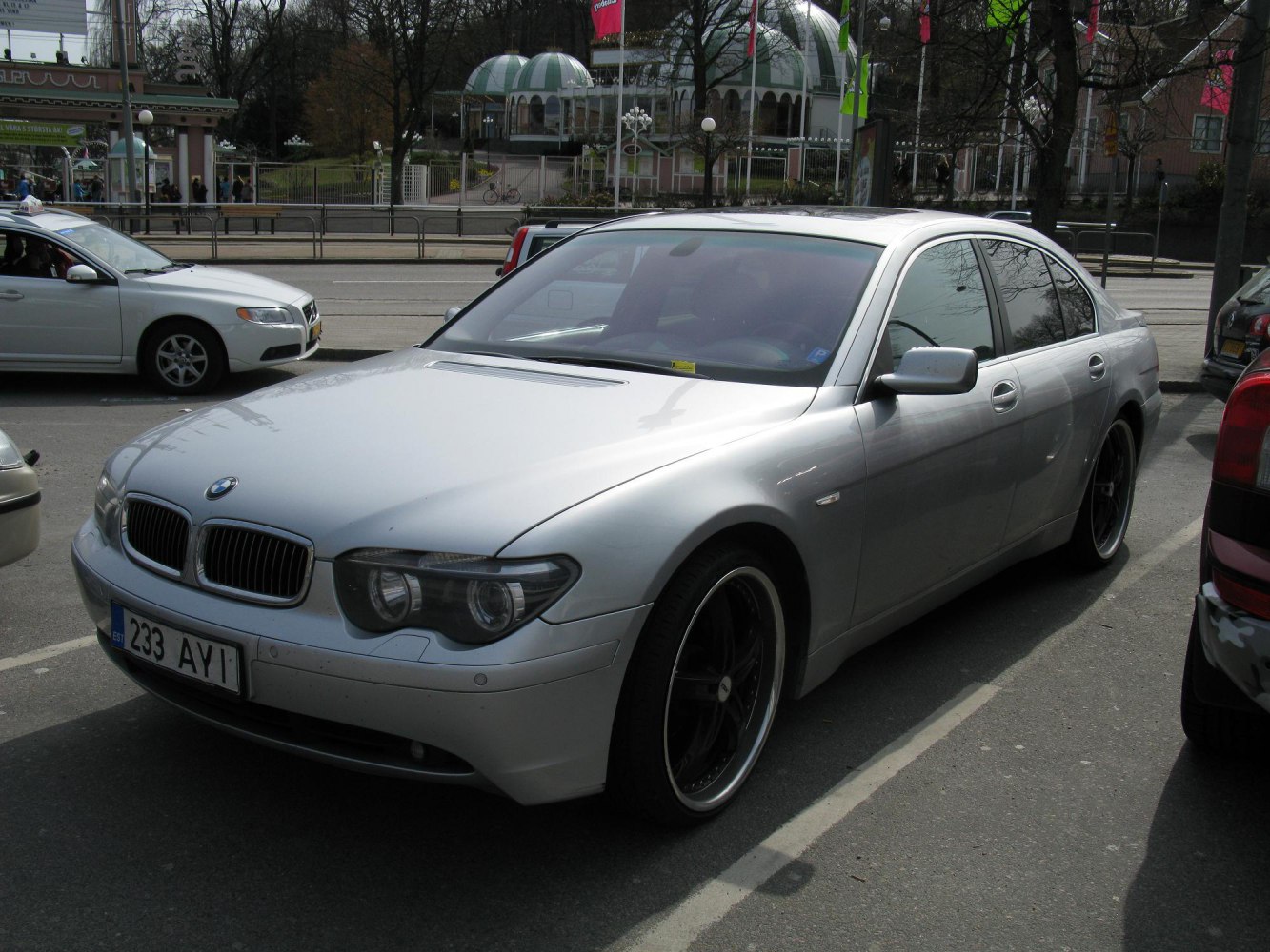 Silver luxury sedan front view with distinctive headlights and alloy wheels