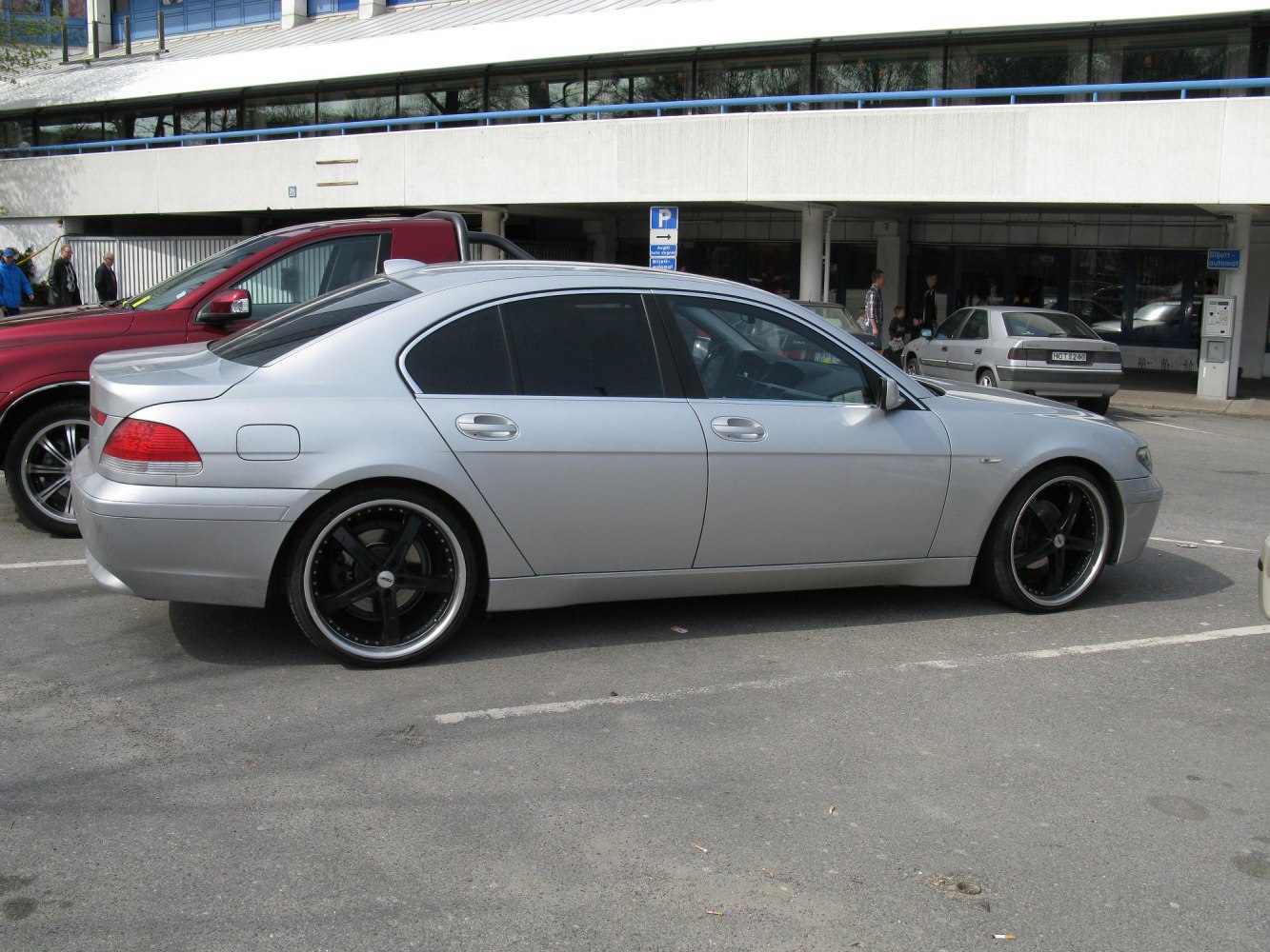 Silver 4-door sedan with black rims and tinted windows