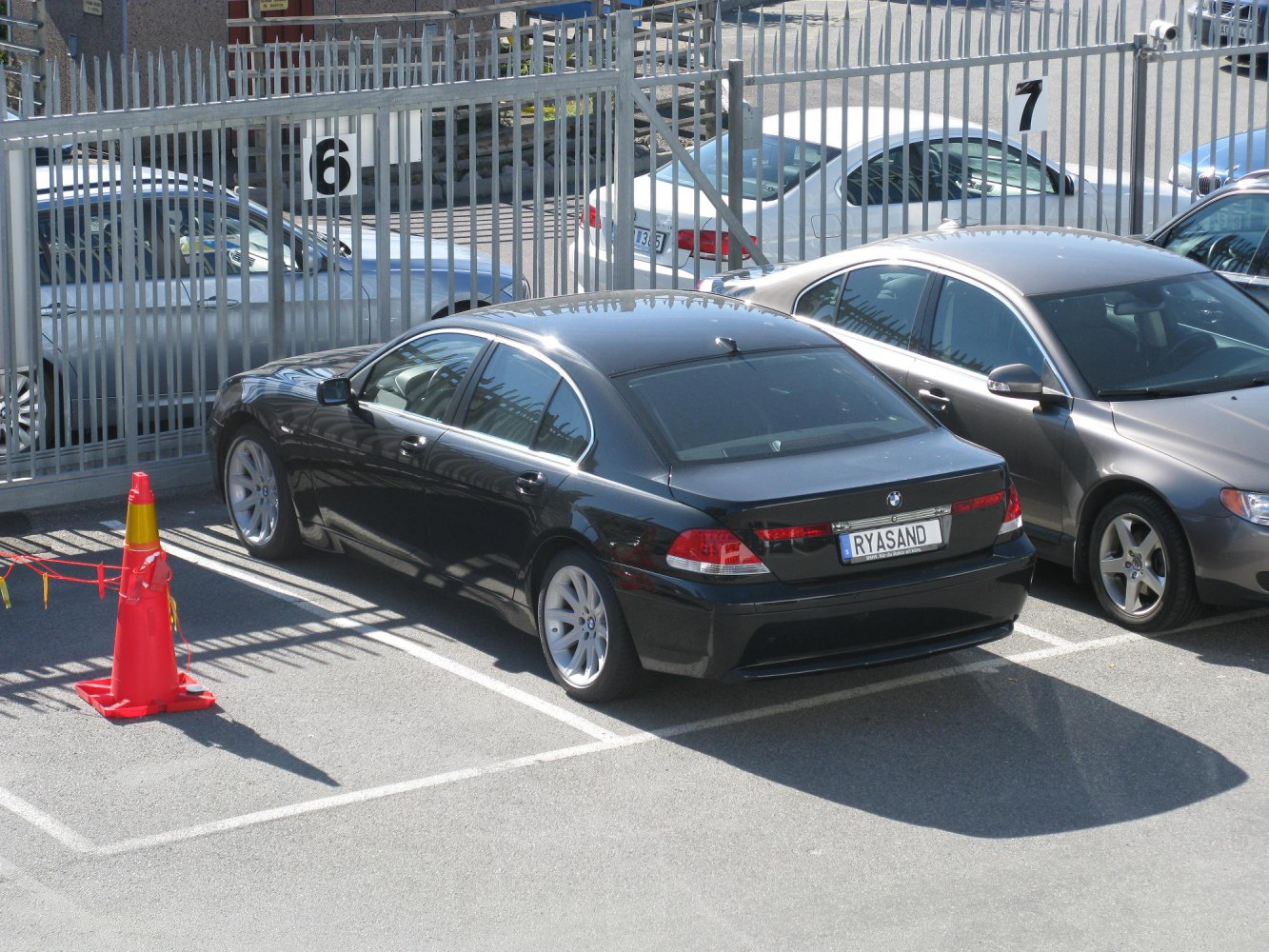 Black luxury sedan rear view with alloy wheels and tinted windows