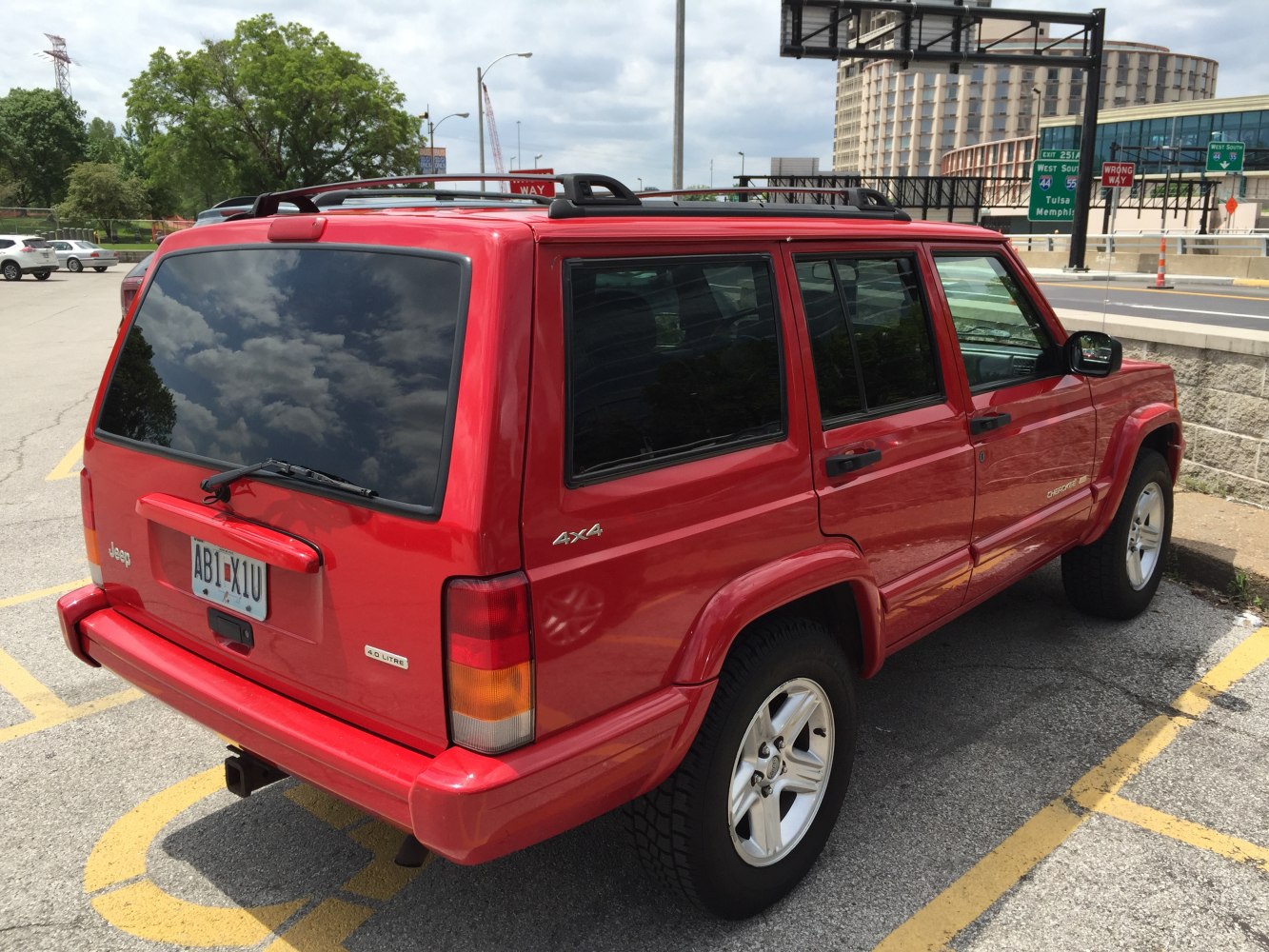 Red 4x4 SUV with roof rails and tinted windows, five-door body style