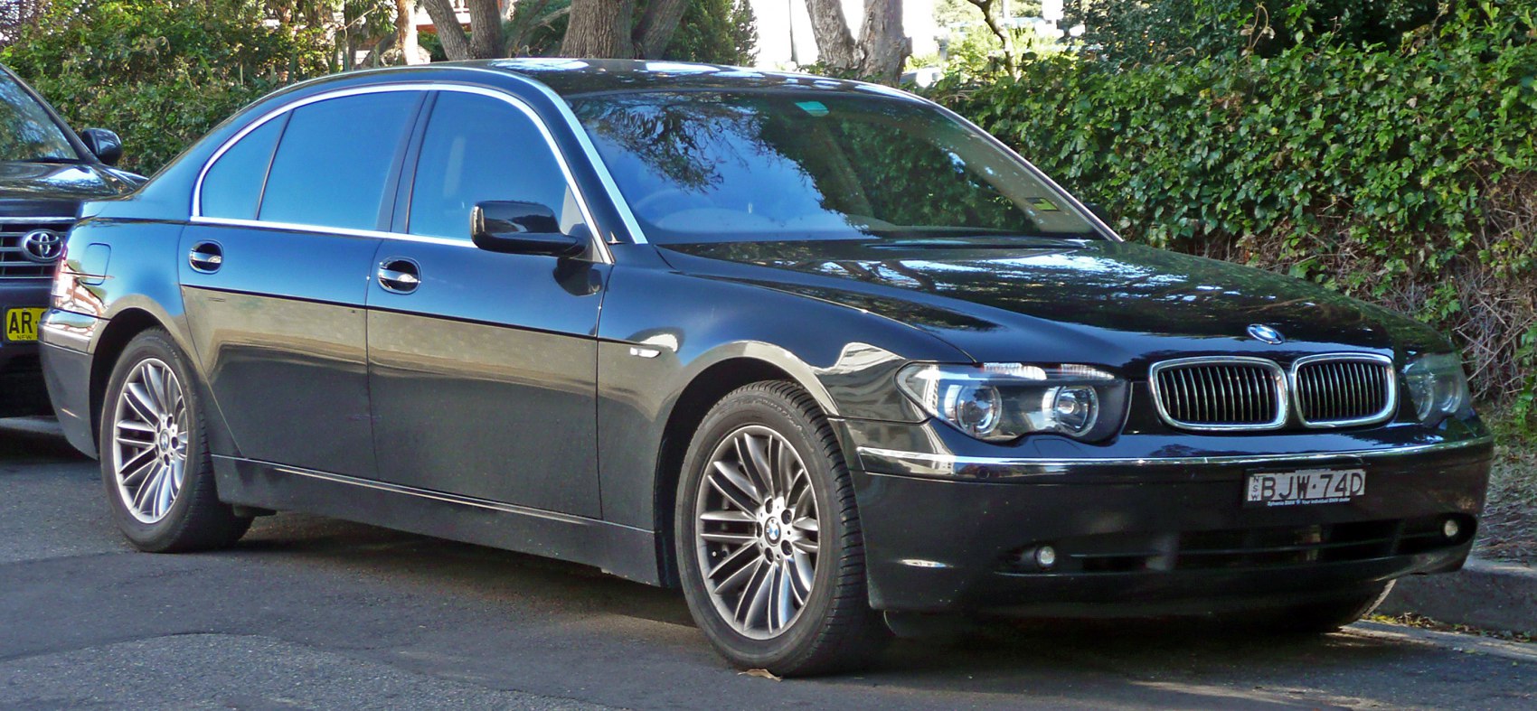 Front side exterior with headlight, grille, and alloy wheels