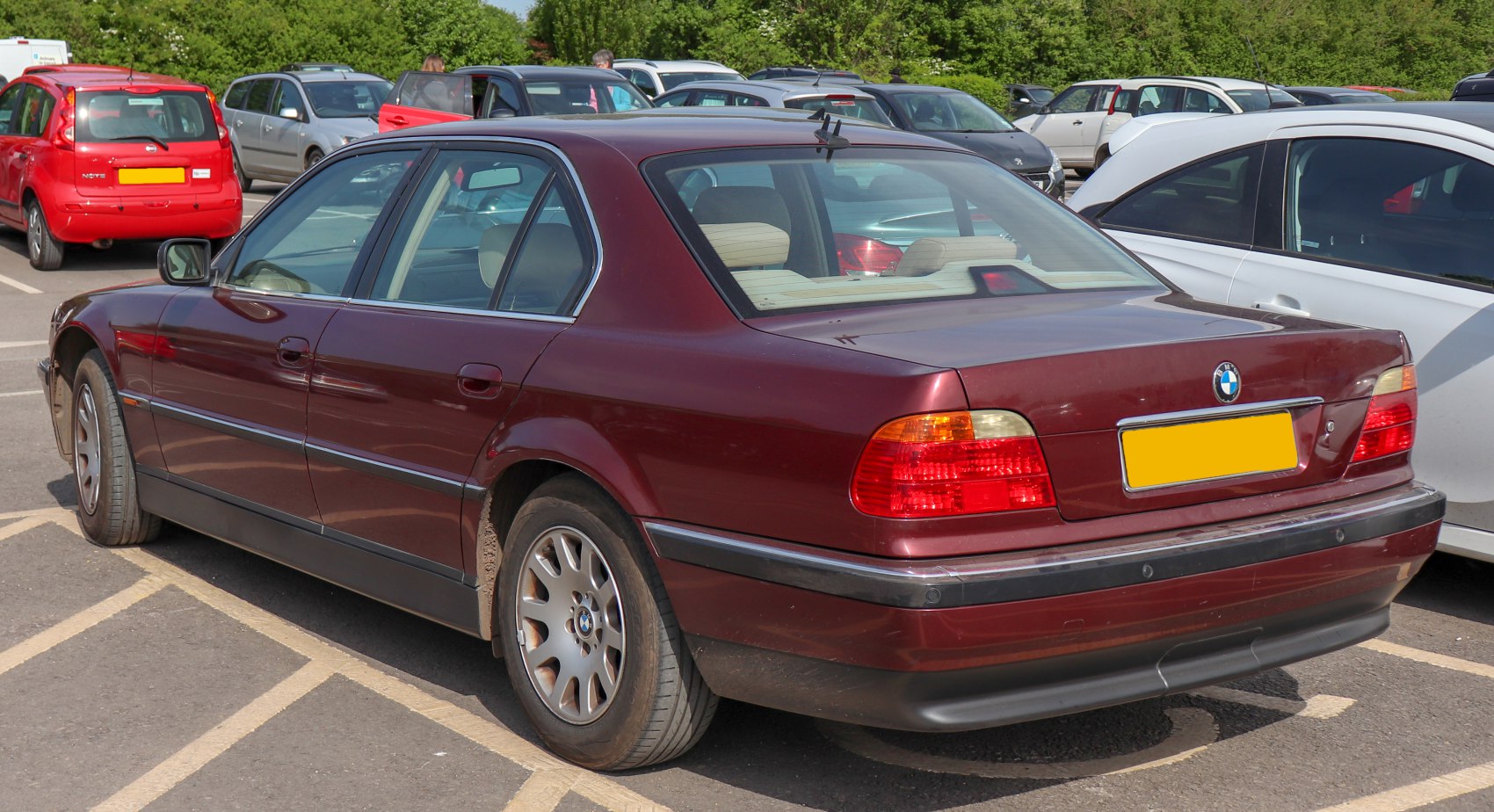 Rear and side profile of a sedan with alloy wheels and tail lights