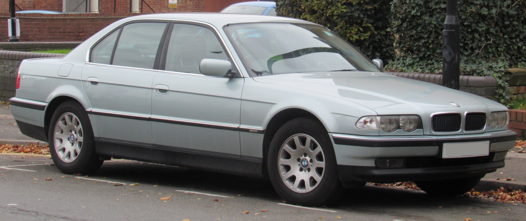 Front and side profile of classic luxury sedan with alloy wheels and distinctive headlights