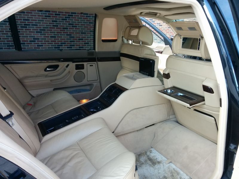 Luxury rear seat with screens and fold-out tray table