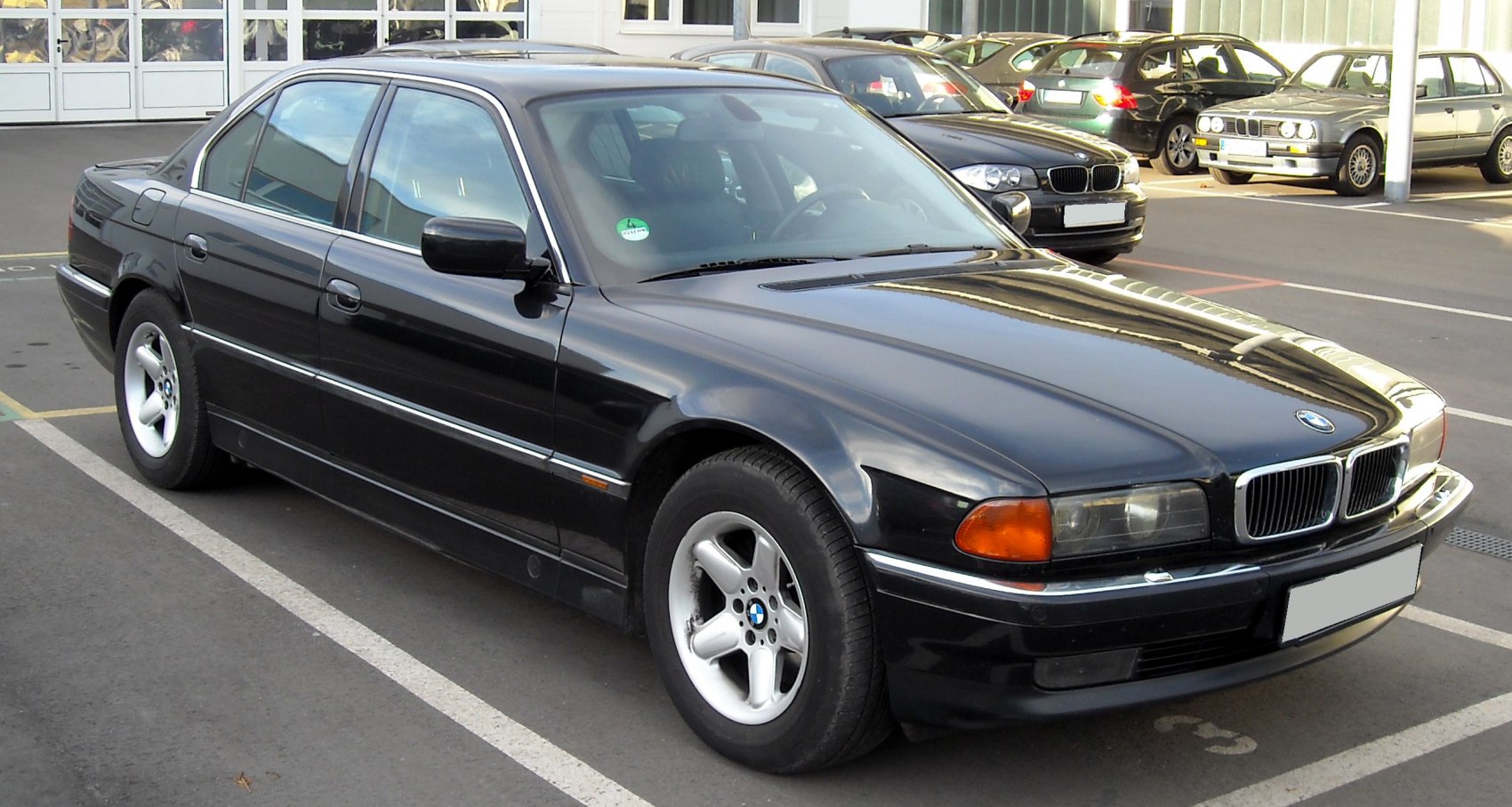 Classic black sedan with distinctive headlights and five-spoke alloy wheels