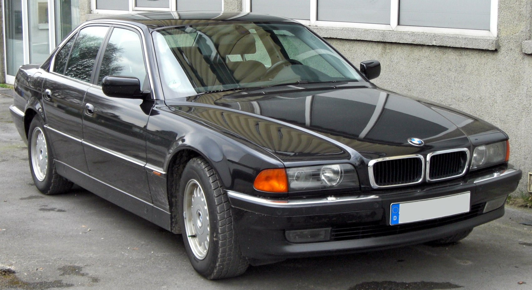 Luxury sedan front side view with distinctive headlights and kidney grille