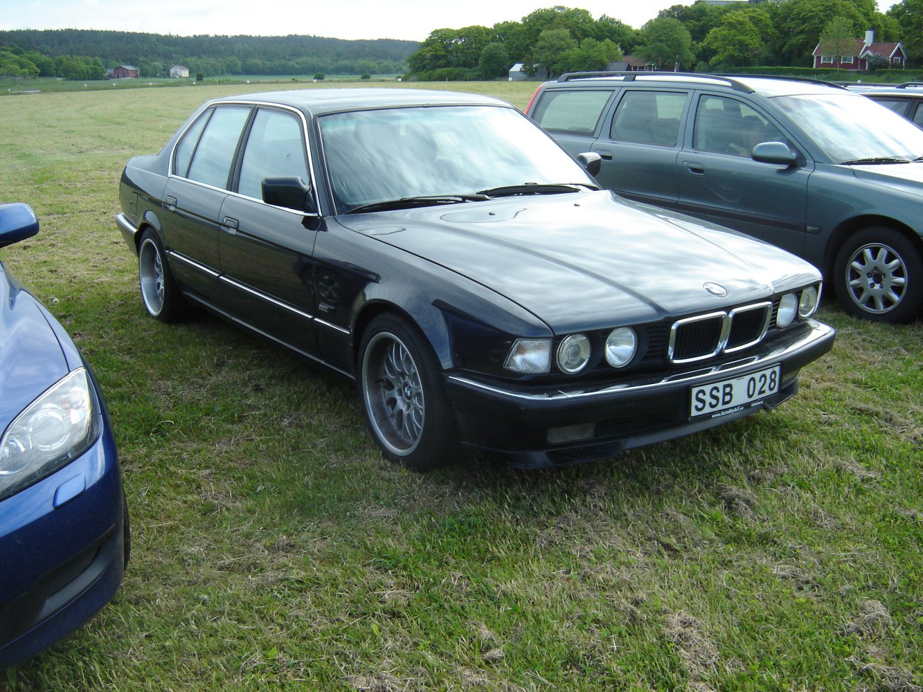 Front and side view of a classic 1992 BMW 7 Series E32 facelift sedan