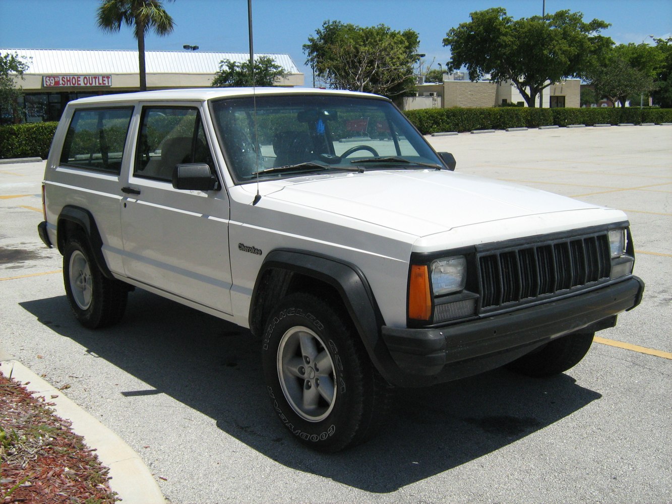 White SUV with boxy design, rugged off-road tires, and distinct grille.