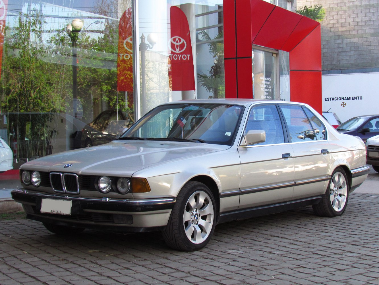 Luxury sedan with quad round headlights and alloy wheels