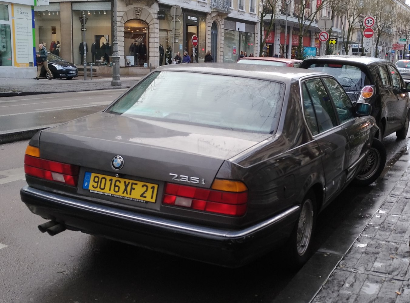 Rear view of classic sedan with dual exhaust and distinct taillights