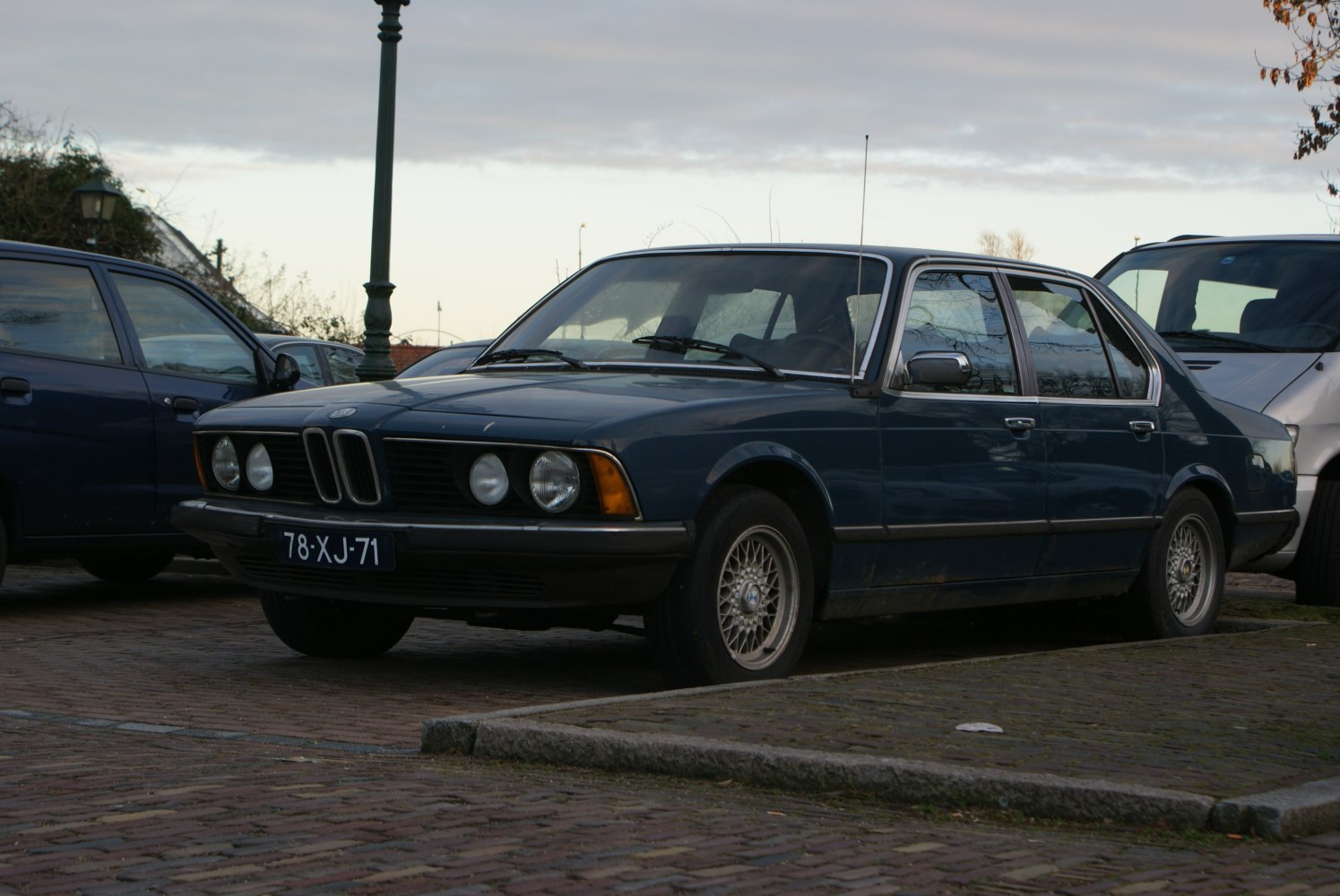 Classic vintage sedan with dual round headlights and alloy wheels